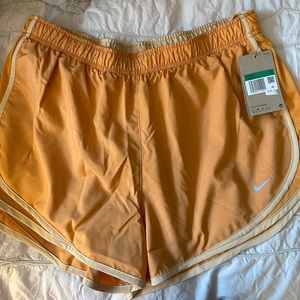 Women’s Nike Tempo Shorts in orange. Size XL, NWT.